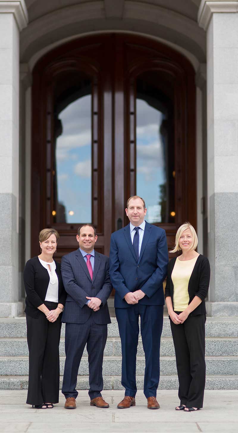 Team Standing In Front of Building