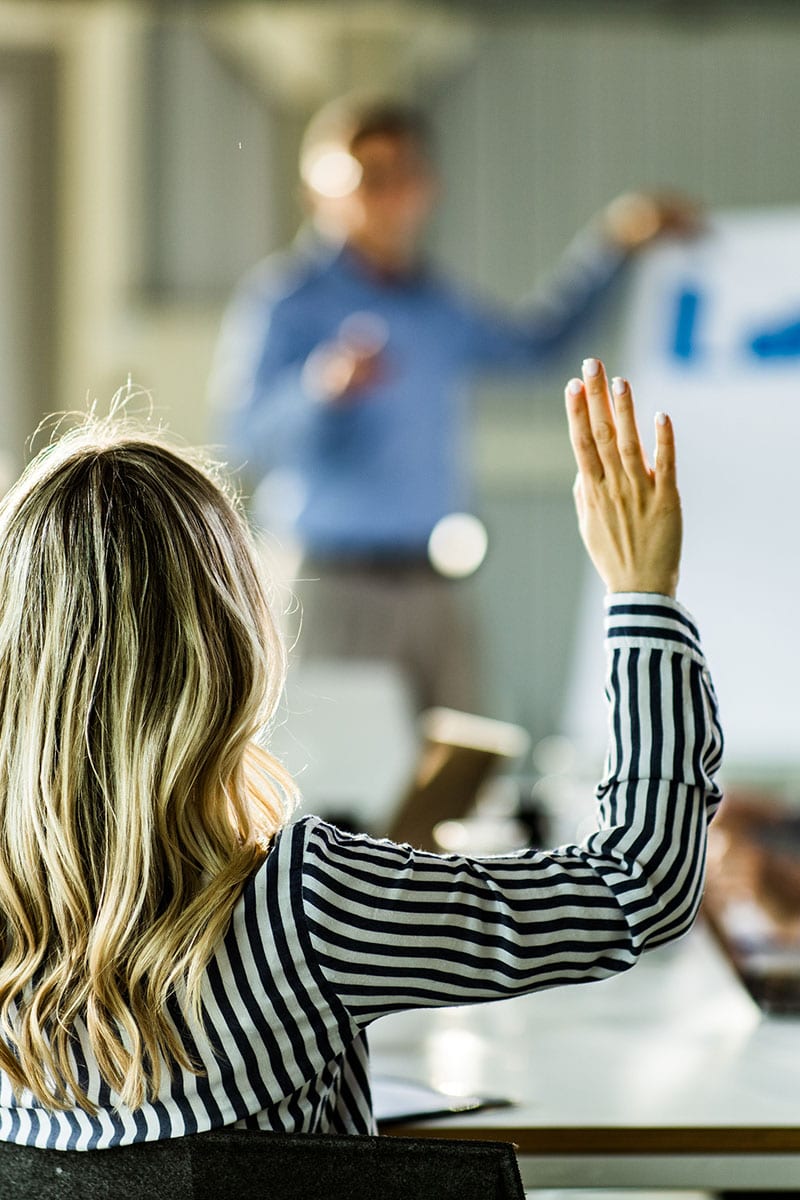 Photo of a woman asking a frequently asked question