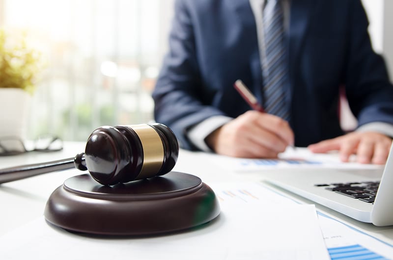 Photo of an attorney working on a case with a gavel