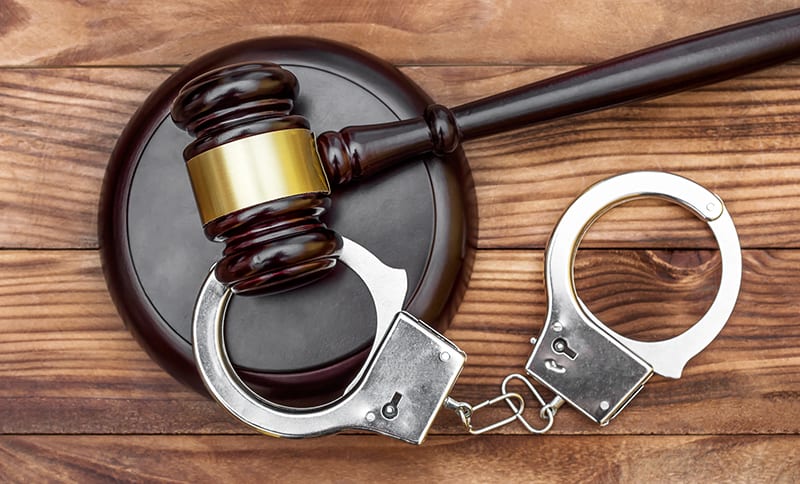 Photo of a gavel and handcuffs