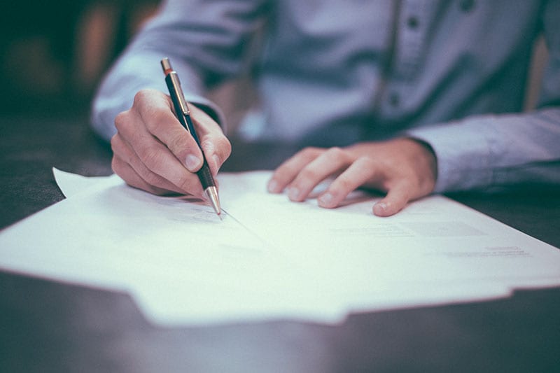 Photo of man filling out Living Trust Legal Documents